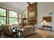Bright living room with vaulted ceiling, brick fireplace, hardwood floors, and large picture windows at 2508 Indian Creek Rd, Trafalgar, IN 46181