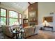 Living room showcasing a fireplace with a brick surround, large windows, and neutral decor at 2508 Indian Creek Rd, Trafalgar, IN 46181