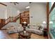 Spacious living room with wood floors, staircase, and comfortable seating area at 2508 Indian Creek Rd, Trafalgar, IN 46181