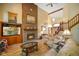 Inviting living room with brick fireplace, vaulted ceilings, wood floors and comfortable seating at 2508 Indian Creek Rd, Trafalgar, IN 46181