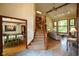 Open-concept living room features a staircase, large windows, and wood floors at 2508 Indian Creek Rd, Trafalgar, IN 46181