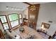 Aerial view of a bright living room with vaulted ceilings, brick fireplace, and large picture windows at 2508 Indian Creek Rd, Trafalgar, IN 46181