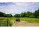 Open field with fencing and mature trees, ideal for agricultural use or equestrian activities at 2508 Indian Creek Rd, Trafalgar, IN 46181