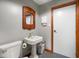 This powder room has a pedestal sink, ornate mirror, and adjacent toilet at 2508 Indian Creek Rd, Trafalgar, IN 46181