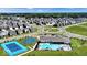 Stunning aerial view of a modern community with a pool, tennis and basketball courts, and manicured landscaping at 2542 Barstow Dr, Whitestown, IN 46075