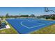 Bright blue basketball court with new hoops and white lines in a modern planned community at 2542 Barstow Dr, Whitestown, IN 46075