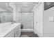 Bright bathroom featuring a tiled shower with glass enclosure, and dual sinks at 2542 Barstow Dr, Whitestown, IN 46075