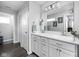 Well-lit bathroom featuring double sinks, modern fixtures, and a large mirror at 2542 Barstow Dr, Whitestown, IN 46075