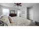 Spacious bedroom boasts neutral decor, a ceiling fan, and access to an en-suite bathroom at 2542 Barstow Dr, Whitestown, IN 46075