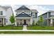 Charming two-story home with blue siding, stone accents, and a well-manicured lawn at 2542 Barstow Dr, Whitestown, IN 46075