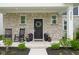 Welcoming front porch featuring stone accents, rocking chairs, and decorative planters at 2542 Barstow Dr, Whitestown, IN 46075