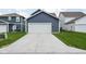 Exterior shot of a well-maintained home featuring a two-car garage at 2542 Barstow Dr, Whitestown, IN 46075