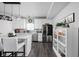 Open-concept kitchen features stainless steel appliances, white cabinetry, and a view of the backyard at 2542 Barstow Dr, Whitestown, IN 46075