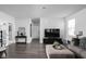 Comfortable living room featuring dark hardwood floors, neutral walls, and stylish furnishings at 2542 Barstow Dr, Whitestown, IN 46075