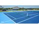 Close-up of a blue tennis court with well-maintained net and lines in a modern community at 2542 Barstow Dr, Whitestown, IN 46075