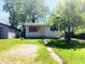 Charming single-story home with a quaint front yard, mature tree, and white siding at 2609 Mars Hill St, Indianapolis, IN 46241