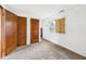 Modest bedroom with boarded window and two large doors, perfect for future updates and design at 29 E Pine St, Anderson, IN 46012