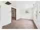 Simple bedroom featuring neutral carpet and a window, awaiting personalization and updates at 29 E Pine St, Anderson, IN 46012
