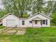 Charming single-story home with attached garage and covered entry on a lush lawn at 29 E Pine St, Anderson, IN 46012
