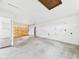 Unfinished garage showing a roll-up door, concrete floor and white walls at 29 E Pine St, Anderson, IN 46012