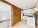 Functional kitchen with essential appliances adjacent to a room with worn carpet at 29 E Pine St, Anderson, IN 46012