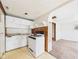 Compact kitchen featuring essential appliances and a view into a carpeted adjacent room at 29 E Pine St, Anderson, IN 46012