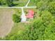 Aerial view of a house with a red roof surrounded by lush greenery and farmland at 295 Maple Turn Rd, Martinsville, IN 46151
