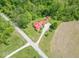 Aerial view of a property with a red roof, outbuildings, lots of land, and surrounded by lush greenery at 295 Maple Turn Rd, Martinsville, IN 46151
