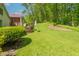 A sprawling backyard featuring a lush lawn, bordered by a wooded area and a deck at 295 Maple Turn Rd, Martinsville, IN 46151