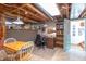A basement with an office space, desk and chair, a table with two chairs, and storage shelves at 295 Maple Turn Rd, Martinsville, IN 46151