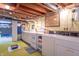 A basement kitchen area with exposed duct work, washer and dryer, and open concept at 295 Maple Turn Rd, Martinsville, IN 46151