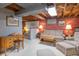 Cozy finished basement with brick accents, wood details, carpet, and comfortable seating at 295 Maple Turn Rd, Martinsville, IN 46151