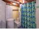 A bathroom featuring a bathtub with a blue and green shower curtain at 295 Maple Turn Rd, Martinsville, IN 46151