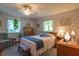 Relaxing bedroom with a ceiling fan, bright windows, and cozy furniture at 295 Maple Turn Rd, Martinsville, IN 46151