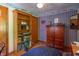 Bedroom features wood floors, trim, and a storage cabinet with a bookshelf, plus airplane-themed wallpaper at 295 Maple Turn Rd, Martinsville, IN 46151