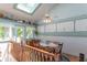 Cozy dining room with a skylight, and charming decor, adjacent to a staircase with wooden railing at 295 Maple Turn Rd, Martinsville, IN 46151
