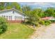 Charming home with a red roof, brick accents, gravel driveway, and landscaped garden at 295 Maple Turn Rd, Martinsville, IN 46151