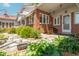 Inviting front porch with brick facade, rocking chair, and beautifully landscaped garden at 295 Maple Turn Rd, Martinsville, IN 46151