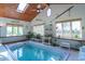 Relaxing indoor pool area with a jacuzzi, wood ceiling, lots of windows, and natural light at 295 Maple Turn Rd, Martinsville, IN 46151