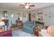Cozy living room featuring floral wallpaper, ceiling fan and comfortable seating arrangement at 295 Maple Turn Rd, Martinsville, IN 46151