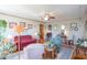 Bright living room with floral wallpaper, ceiling fan, area rug, and comfortable seating arrangements at 295 Maple Turn Rd, Martinsville, IN 46151
