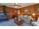 Comfortable living room with wood paneled walls, ceiling fan, fireplace, and comfortable seating at 295 Maple Turn Rd, Martinsville, IN 46151