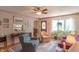 Charming living room with floral wallpaper, comfortable seating, and large windows with outdoor views at 295 Maple Turn Rd, Martinsville, IN 46151