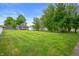 Expansive backyard featuring lush lawn and mature trees, perfect for outdoor activities and relaxation at 3019 W Huntsville Rd, Pendleton, IN 46064