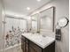 Bathroom featuring double sinks, modern mirrors, and a shower with a floral curtain at 3019 W Huntsville Rd, Pendleton, IN 46064