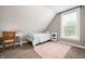 Cozy bedroom with desk, sloped ceilings, and a patterned rug at 3019 W Huntsville Rd, Pendleton, IN 46064