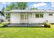Back of the home with a covered patio and a well-manicured lawn and garden at 3022 Cameron St, Indianapolis, IN 46203