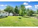 A large backyard featuring a storage shed, mature trees, and a charming footbridge at 3022 Cameron St, Indianapolis, IN 46203