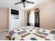 Comfortable bedroom features a ceiling fan, TV, a large closet, and a lovely quilt on the bed at 3022 Cameron St, Indianapolis, IN 46203