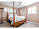 Bedroom with a ceiling fan, carpet flooring, natural light from the windows, and a four-poster bed at 3022 Cameron St, Indianapolis, IN 46203